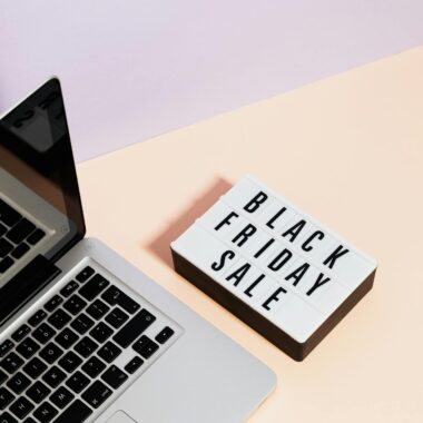 Minimalist laptop scene with black friday sale sign, perfect for retail marketing visuals.